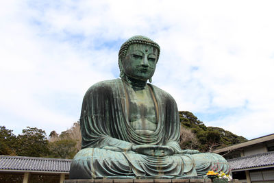 Low angle view of statue against sky