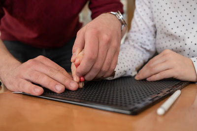 Midsection of woman using laptop