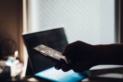 Cropped hand of person using mobile phone