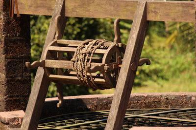 Close-up of rope rolled on metal at well