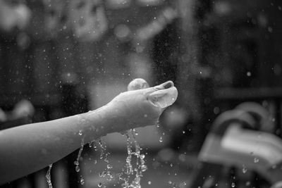 Close-up of hand holding water balloon