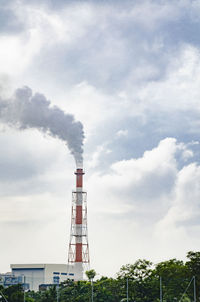 Low angle view of smoke stack against sky