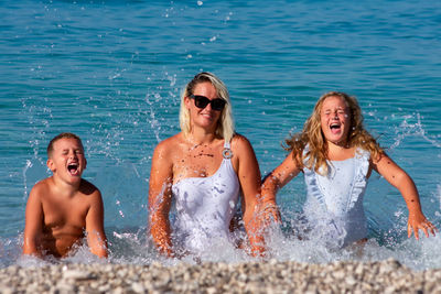 Happy friends enjoying in swimming pool