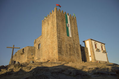 Low angle view of fort against clear blue sky