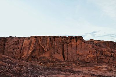 Rock formations on landscape against sky