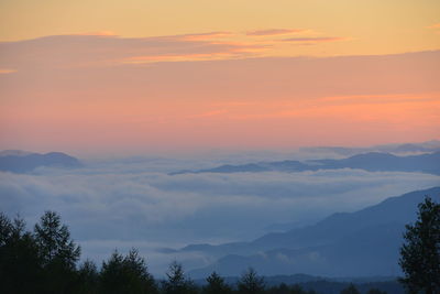 Scenic view of mountains against sky at sunset