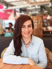 Portrait of smiling woman sitting at restaurant