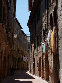 Street amidst buildings against sky in city