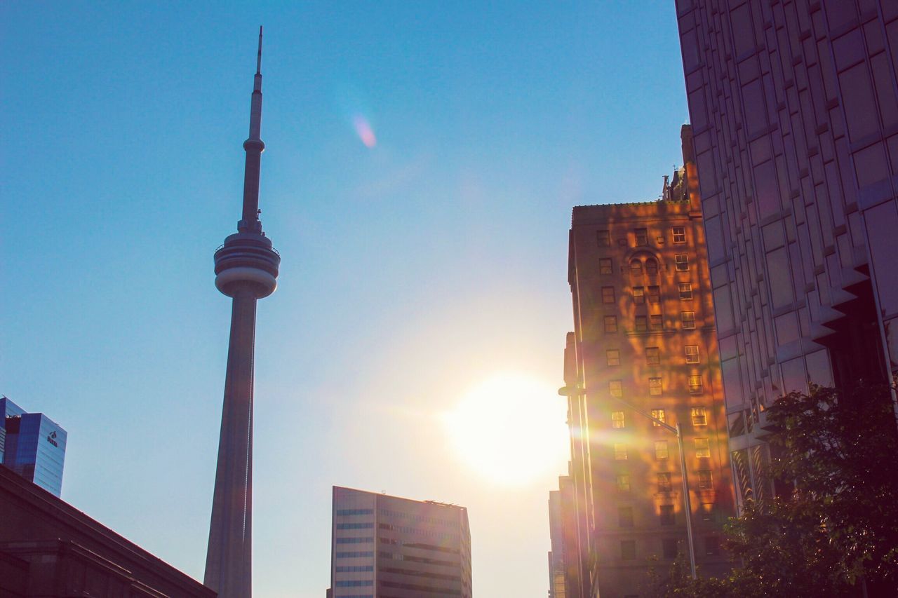 LOW ANGLE VIEW OF COMMUNICATIONS TOWER IN CITY