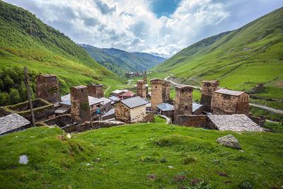 Scenic view of old building by mountains against sky