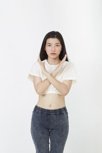 Portrait of beautiful young woman against white background