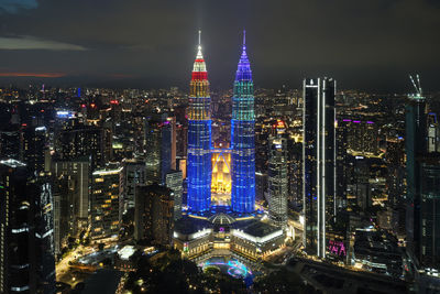 High angle view of illuminated buildings in city at night