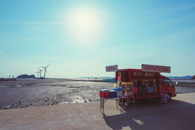 Tractor on beach against clear sky