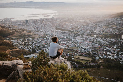 Rear view of man looking at cityscape