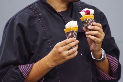 Midsection of man holding ice cream