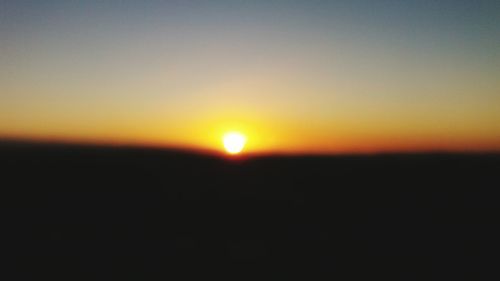 Scenic view of silhouette landscape against clear sky during sunset