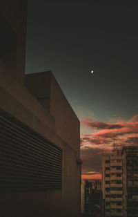 Low angle view of buildings against sky at night