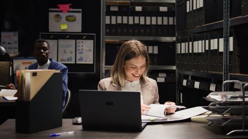 Young woman using laptop at table