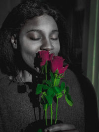 Close-up of woman with red flower