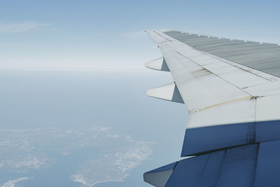 Airplane wing against sky