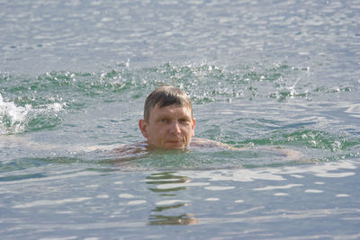 Portrait of man swimming in pool