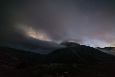 Scenic view of illuminated mountains against sky at night