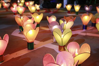 Close-up of illuminated candles on flower