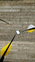 Close-up of yellow darts on board