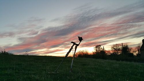 Silhouette of field against sky during sunset