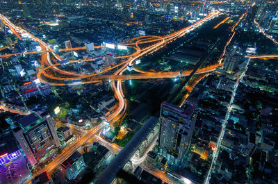 High angle view of illuminated city street and buildings at night