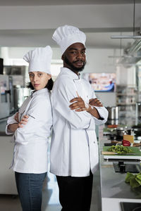 Confident chefs standing in kitchen