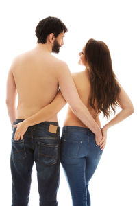Rear view of couple standing against white background