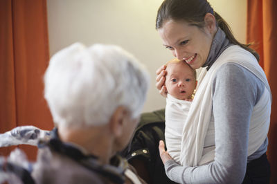 Old woman meeting her great granddaughter