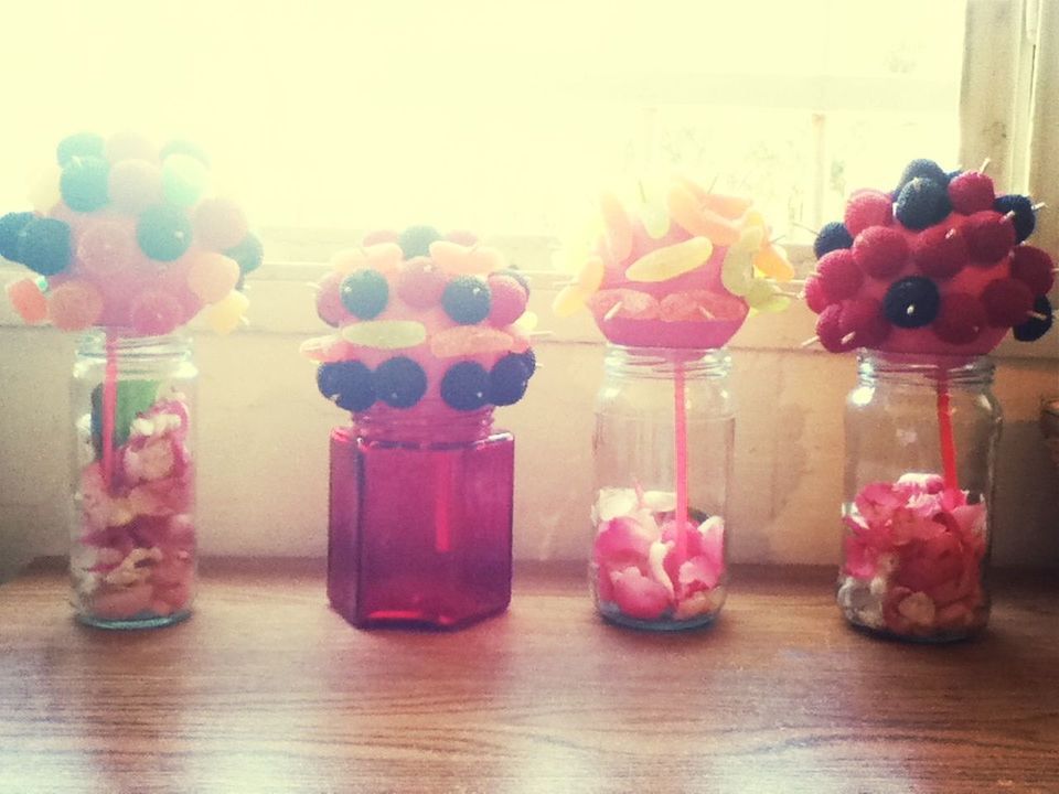 flower, indoors, freshness, vase, table, fragility, home interior, petal, pink color, wood - material, decoration, still life, flower arrangement, rose - flower, glass - material, flower head, bouquet, close-up, wall - building feature, bunch of flowers