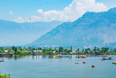 Scenic view of sea and mountains against sky