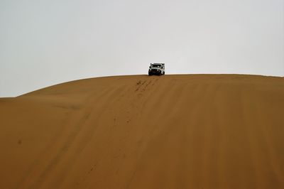 Low angle view of desert against clear sky