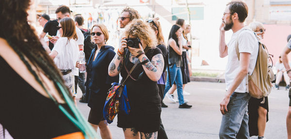 Group of people photographing in city