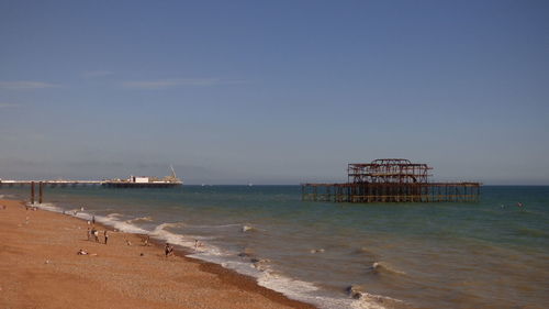 Historic west pier in sea against sky