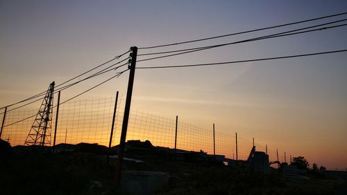 Silhouette city against sky during sunset