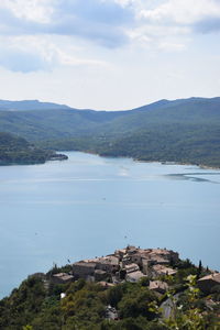 Scenic view of sea and mountains against sky