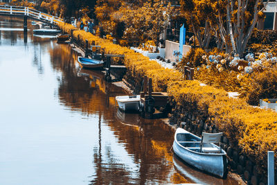 Boats moored on river during autumn