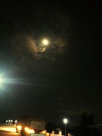 Low angle view of illuminated street light against sky at night