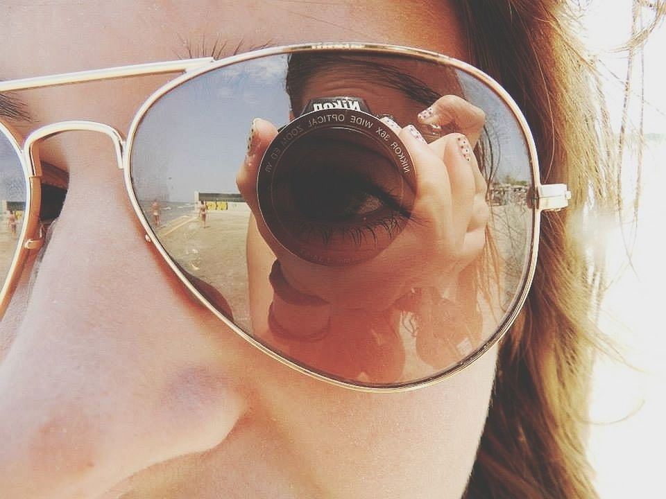 lifestyles, sunglasses, close-up, leisure activity, photography themes, holding, indoors, part of, photographing, reflection, person, day, drink, headshot, camera - photographic equipment, men