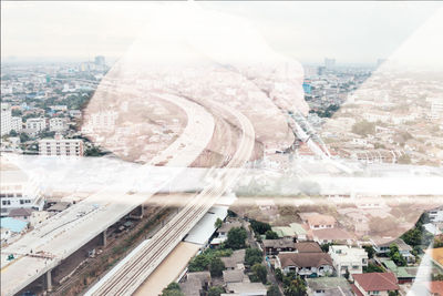 Aerial view of city and buildings against sky