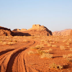 Scenic view of arid landscape against clear sky