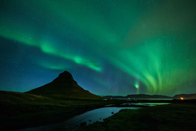 Scenic view of aurora polaris over kirkjufell mountain