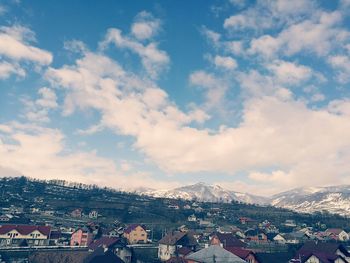 Houses in town against sky