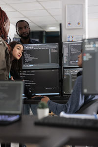 Portrait of young woman using laptop at office