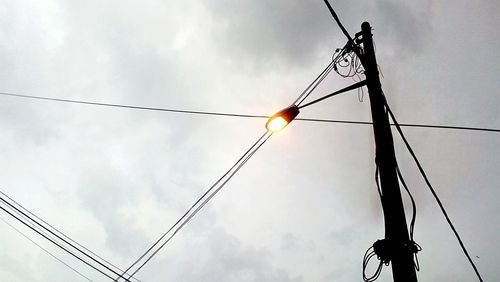 Low angle view of cables against sky