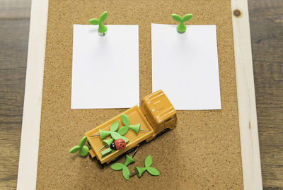 High angle view of toy truck on papers over table
